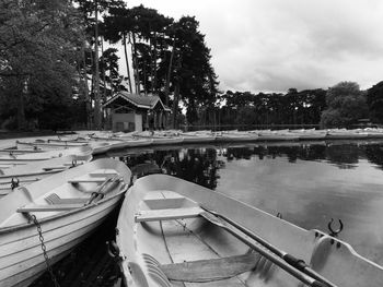 Boats moored in lake against sky