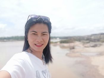 Portrait of smiling young woman on beach