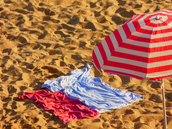 Umbrella and towels at sandy beach