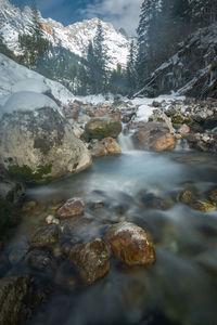 Scenic view of river against snowcapped mountains