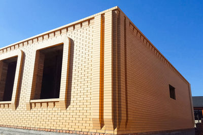 Low angle view of building against clear blue sky