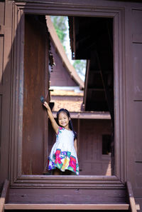 Portrait of woman against building