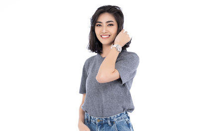 Portrait of a smiling young woman against white background