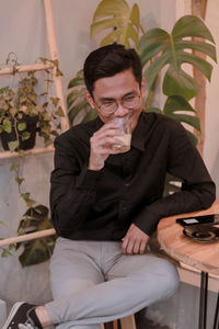 Young man drinking glasses