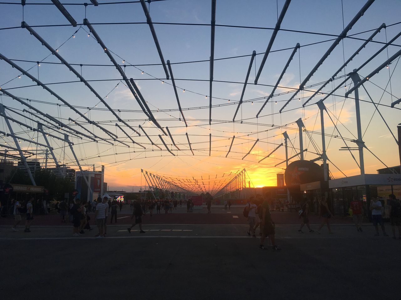 GROUP OF PEOPLE WALKING ON ORANGE SKY DURING SUNSET