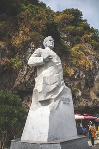 Statue against trees