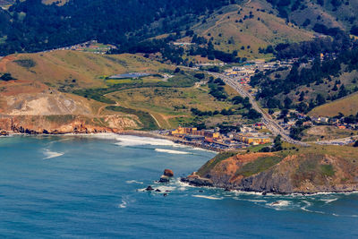 Scenic view of sea and mountains against sky