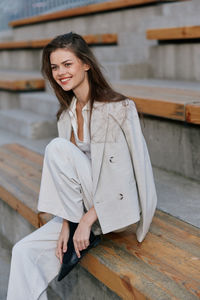 Portrait of young woman sitting on steps