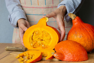 Midsection of man holding pumpkin