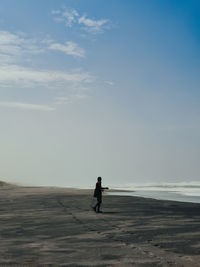 Man on beach against sky