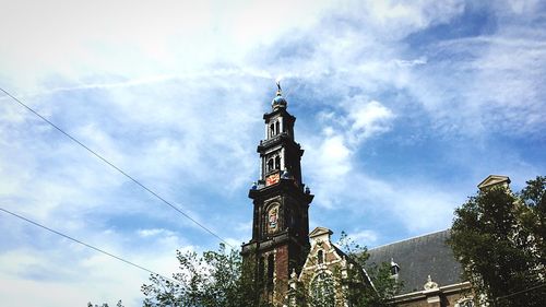 Low angle view of tower against cloudy sky