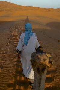 Man riding horse on sand