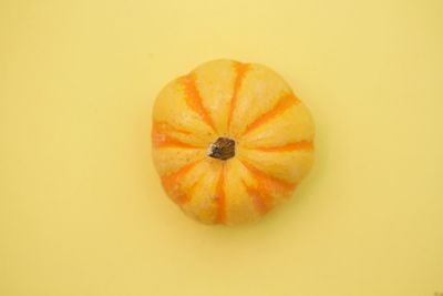 Orange pumpkins in yellow background