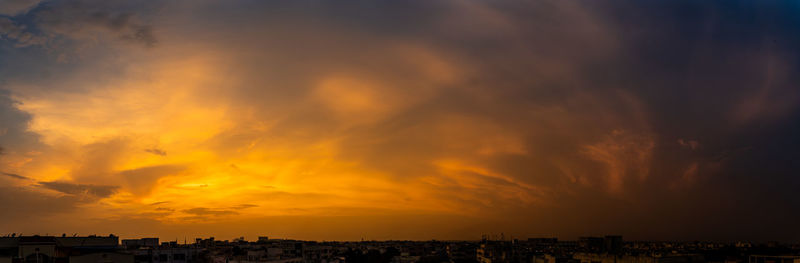 Panoramic view of buildings against sky during sunset