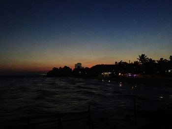 Scenic view of sea against clear sky at dusk