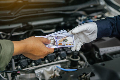Midsection of man repairing car
