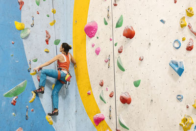 Woman climbing on wall