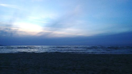 Scenic view of beach against sky during sunset