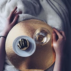 High angle view of woman holding coffee cup on table