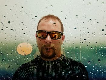 Portrait of a smiling man in rain