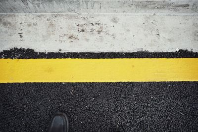 High angle view of yellow road sign on street