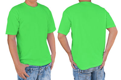 Rear view of friends standing against white background