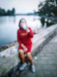 Woman looking away while standing in water