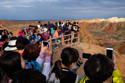 People photographing dramatic landscape at zhangye danxia national geological park