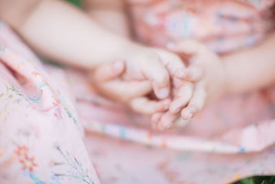 Close-up of children holding hands