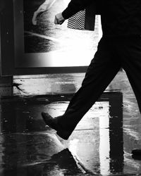 Low section of man with reflection in puddle