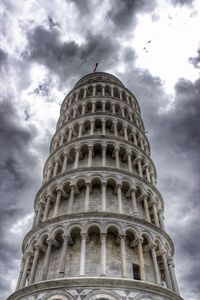 Low angle view of eiffel tower against cloudy sky
