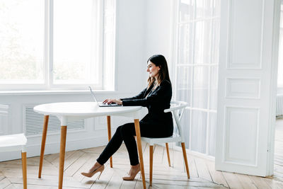 Woman sitting on chair at home