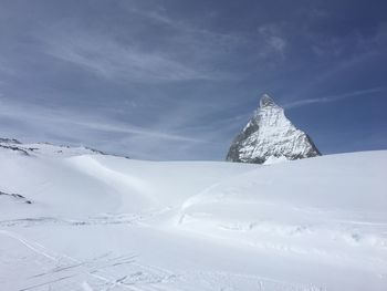 Aerial view of snow covered landscape against sky