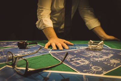 Midsection of man playing with table