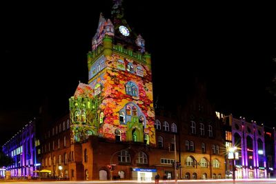 Low angle view of illuminated buildings in city at night