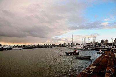 Pier on sea against cloudy sky