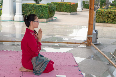 Side view of woman praying outdoors