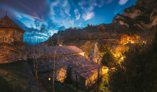 Panoramic view of buildings and trees against sky