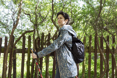 Young woman standing in forest