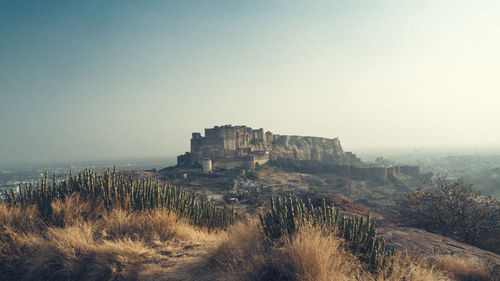 Mid distance view of mehrangarh fort against clear sky