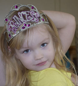 Close-up portrait of girl wearing princess crown