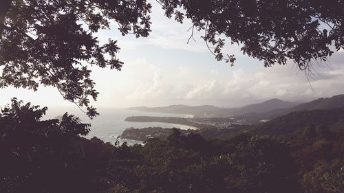 Scenic view of mountains against cloudy sky