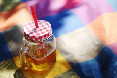 High angle view of whiskey in jar on fabric