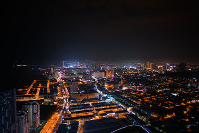 High angle view of illuminated buildings in city at night