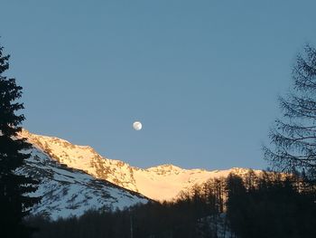 Scenic view of snowcapped mountains against clear sky