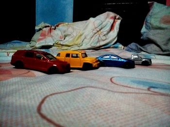 Close-up of toy car on bed at home