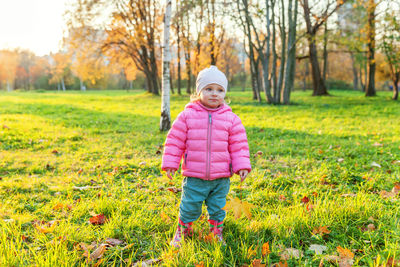 Portrait of boy standing on field