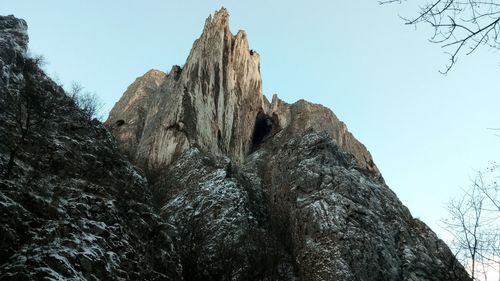 Low angle view of rock formation against clear sky