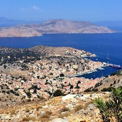 High angle view of city by sea against sky