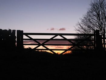 Silhouette bridge against sky during sunset